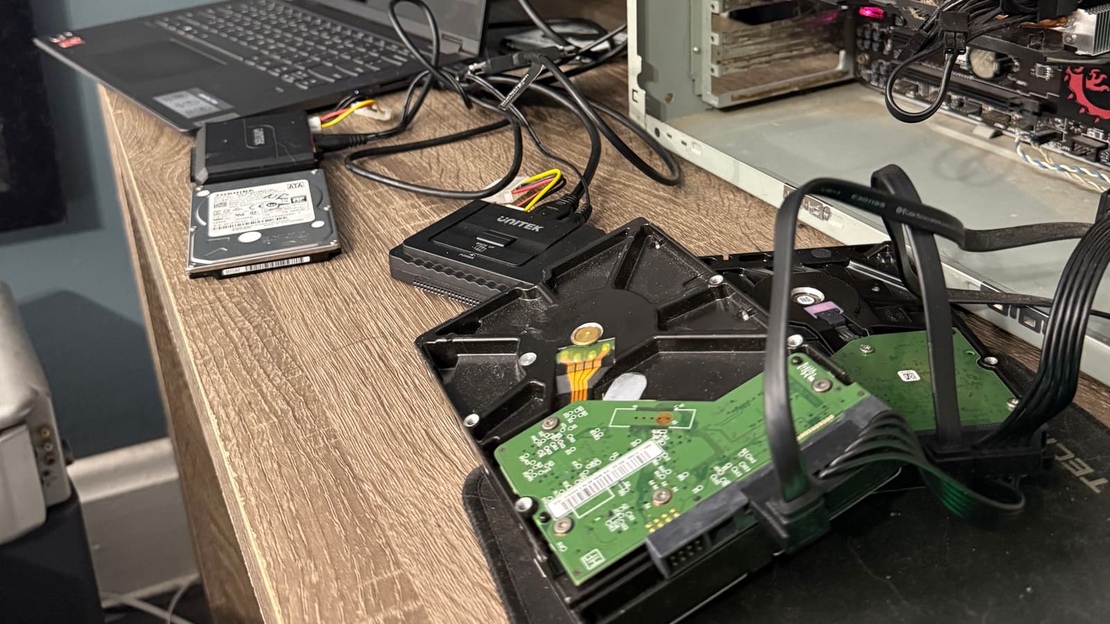 Drive imaging in progress at The Attic Lab in Pittsburgh: bare hard drives connected through USB-SATA bridges to a recovery laptop